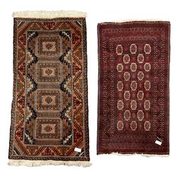 Persian indigo and dark rust ground rug, the field decorated with four large Gul motifs with geometric design borders (174cm x 90cm), and a Tekke Bokhara red ground rug (165cm x 86cm)