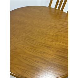 Traditional style beech dining table, circular top raised on turned column and four reeded splayed supports (D101cm) together with a set of three dining chairs (W45cm)