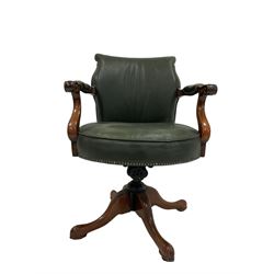 Late 19th century swivel desk chair, upholstered in green leather with scrolled arm rests 