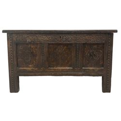 18th century oak blanket chest, rectangular hinged lid with moulded decoration, the frieze carved with strapwork decoration, three panels to the front each carved with foliate lozenges, raised on stile supports 