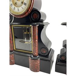Mougin of Paris – late 19th century 8-day Belgium slate mantle clock with a pair of conforming tazas, waisted case with glazed front panel and visible twin file mercury pendulum, projecting semi-circular rouge and white flecked marble columns on a broad rectangular plinth, two-part enamel dial with a glazed cast brass bezel, visible Brocot dead beat escapement with jewelled cornelian pallets, Roman numerals and steel fleur di Lis hands, count wheel striking movement striking the hours and half hours on a bell. Tazzas H27cm.
