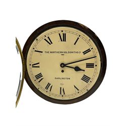 An English 20th century eight-day wall clock with an Enfield spring driven movement and lever platform escapement, a twelve-inch white painted dial with Roman numerals and minute track, steel spade hands with fast/slow regulation, flat bezel with silver sight ring and spun bezel, dial inscribed “ The Northern Goldsmiths Co, Darlington”,  fourteen-inch circular oak veneered case. With key.  