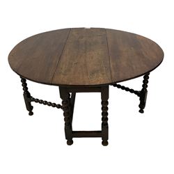 18th century drop-leaf oak dining table, oval top fitted with two drawers, raised on bobbin-turned supports with double gate-leg action, united by stretchers with carved rails