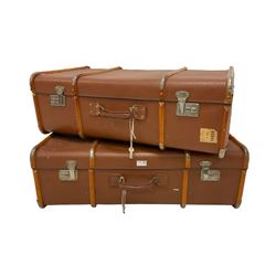 Two vintage wood bound travelling trunks in brick red colour 