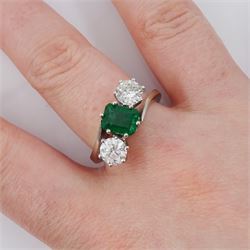 18ct white gold three stone octagonal cut emerald and round cut diamond crossover ring, stamped 750, emerald approx 0.95 carat, total diamond weight approx 1.35 carat