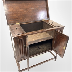 Early 20th century oak gramophone cabinet converted to use a a cupboard, with hinged lid over four doors, raised on turned supports, W96cm, H97cm, d49cm