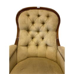Late 19th century mahogany framed armchair, high spoonback upholstered in buttoned textured fabric with sprung seat, scrolled arm terminals raised on turned supports with castors