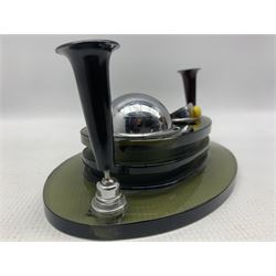 Mid century olive green glass desk stand, having two inkwells with revolving chrome covers and two Bakelite pen holders, L20cm 
