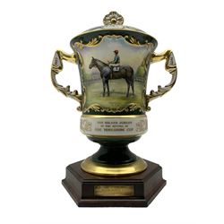 Limited edition Aynsley twin-handled racing cup and cover commemorating 'The Golden jubilee of the revival of The Yorkshire Cup', the handles inscribed '1927' and '1977', the front panel painted by E. Woodhouse with Joe Childs up on Trimdon, the reverse with the winners, limited number 8/50, upon a hexagonal wooden plinth with brass plaque inscribed No. 8 William Jackson Esquire, with Gibley Racing Limited certificate and original box
