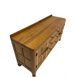 'Mouseman' oak sideboard, fitted with three drawers and two panelled cupboards, adzed top, panelled sides, wrought iron hinges, carved with mouse signature, by Robert Thompson of Kilburn W152cm, H81cm, D47cm