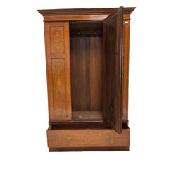 Edwardian mahogany wardrobe, the projecting cornice over single oval mirror panelled door, opening to reveal interior fitted for hanging, over one drawer, raised on plinth base 