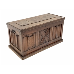 20th century pitch pine blanket box, panelled and carved with linen folds, wrought metal carry handle to each end, raised on skirted base, W104cm