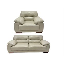 Contemporary three seat sofa, upholstered in cream leather and raised on block supports (W220cm) together with a matching armchair (W120cm)