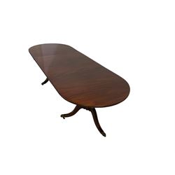 Regency design mahogany twin pedestal dining table, the oval top with reeded edge raised on turned vasiform pedestal terminating in a tripod base, the splayed cabriole supports with brass hairy paw feet and castors, with additional leaf