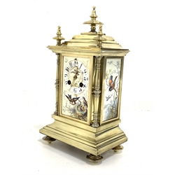 20th century brass mantel clock, three finials over caddy top and three panels painted with birds and Arabic chapter ring, stepped base under, eight day movement striking hammer on coil  