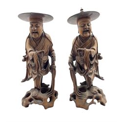 Pair of Chinese carved hardwood standing figures each holding prayer beads and on pierced bases H36cm