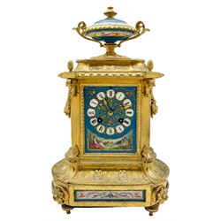 Gilt and porcelain mounted mantle clock, third quarter 19th century, with five Sevres style porcelain panels and urn, Roman numeral cartouche dial decorated with a shepherd and shepherdess in 18th century dress within light blue and gilt borders, with a twin-handled garland decorated urn above, case with reeded canted corners on a shaped plinth base with cast disc feet, eight-day rack striking Parisian movement striking the hours and half-hours on a bell, movement stamped Japy Feres Paris.
With key and pendulum



