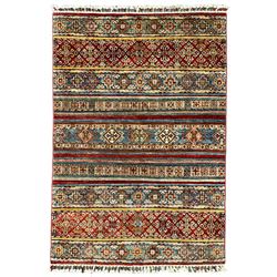 Pakistani Khurjeen multi-coloured rug, the field decorated with rows of varying geometric motifs in alternating colour, comprising lozenges and roods with stylised plant motifs