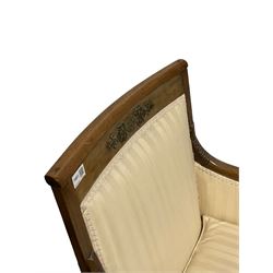 French empire design armchair, the mahogany cresting rail with gilt metal mounts over seat and back upholstered in striped ivory fabric, raised on square tapering supports 