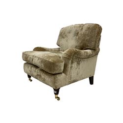 Laura Ashley - wide seat armchair, upholstered in champagne coloured crushed velvet fabric, raised on turned feet with brass castors