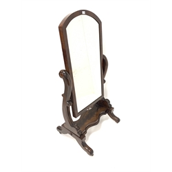 Victorian mahogany cheval dressing mirror, with original arched swing mirror plate, raised on floral carved uprights leading to platform and four out splayed supports terminating in castors 