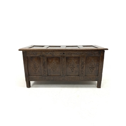 17th century oak coffer, four panelled lid revealing plain interior, scroll carved frieze and lozenge carved front, raised on stile supports, 133cm x 57cm