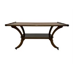Regency design mahogany coffee table, rectangular top with inset leather surface, the sides carved with reeding, under-tier with chamfered corners raised on splayed supports terminating in hairy paw feet and castors