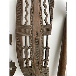 Pair of African carved wooden paddle clubs, African hide shield, Zulu and other spears and a long bow with incised decoration L133cm (11)