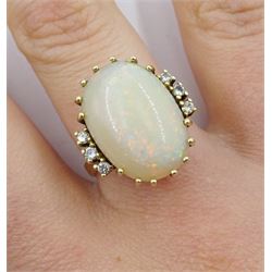 14ct gold oval opal ring, each side set with three diamonds, stamped 585