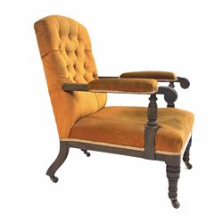 Late Victorian mahogany open armchair, with buttoned back, turned arm terminals and front supports, raised on castors, bearing a paper label inscribed 'Marsh Jones and Cribb' 62cm