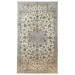 Persian Kashan ivory ground rug, the central floral pole medallion with extending palmettes and interlacing foliate designs, the triple band border decorated with repeating stylised flower heads