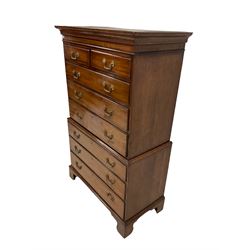 George III oak and mahogany chest-on-chest, projecting shaped cornice, fitte with two short and six long drawers each with moulded edges and brass handles, raised on bracket feet
