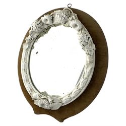 Victorian Royal Worcester glazed white Parian mirror, of oval form with moulded frame applied with flowers and foliage, with Royal Worcester back stamp and indistinct date code, possibly for 1868, in wooden easel frame with fretwork support, 36cm x 31cm, with an accompanying letter 
