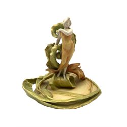 Early 20th century Amphora Austria, Art Nouveau table centrepiece, modelled as as a maiden surrounded by large entwined lilies, stamped beneath & numbered 742/1, H22cm x W21cm