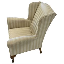 George III design wingback armchair, upholstered in striped ivory fabric with scrolled arms, raised on cabriole supports