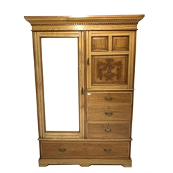 Late Victorian satin walnut wardrobe, the left hand side enclosed by bevelled  mirror door, two carved panel cabinet doors enclosing shelves above five graduating drawers, shaped plinth base