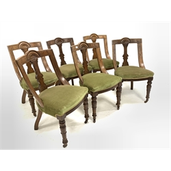 Set six Late Victorian oak dining chairs, lunette carved crest rail over upholstered seats, raised on turned front supports and castors