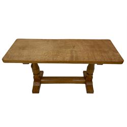 Mouseman - oak coffee table, rectangular adzed top, octagonal pillar supports on sledge feet united by floor stretcher, carved with mouse signature, by the workshop of Robert Thompson, Kilburn 