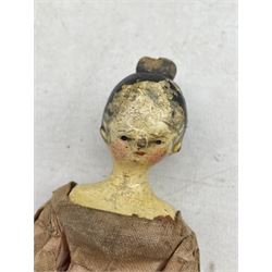 19th century wooden peg doll with painted hair face and shoes, wearing a cotton dress, L22.5cm 