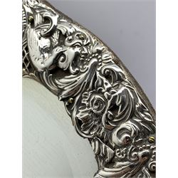 Edwardian silver heart shape dressing table mirror with embossed bird and scroll decoration, bevelled plate and on an easel stand 39cm x 28cm maximum London 1903 Maker William Comyns