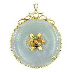 Gold circular jade pendant with central gold and stone set decoration, stamped 14K