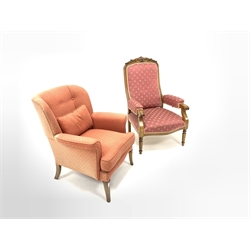 20th century beech reclining open armchair, floral carved crest rail over seat and back upholstered in pink fabric, raised on turned supports (W65cm) together with another 20th century armchair (W70cm)