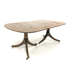 Regency design mahogany dining table with cross banded top raised on two pedestals each with reeded splayed supports and hairy paw castors, with two additional leaves, 201cm x 107cm, H74cm  