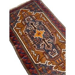 Small Persian Baluchi rug, decorated with geometric motifs within a shaped field, the spandrels decorated with plant patterns, scrolling border 