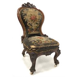 Mid 19th century Irish mahogany hall chair, pierced and carved scrolling acanthus leaf pediment over shaped balloon back, seat and back with needle work upholstery, the apron and cabriole supports with further floral carving and hairy paw feet, raised on ceramic castors W44cm