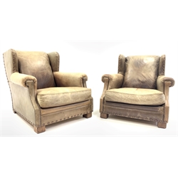  Ralph Lauren for Harrods - Pair of deep wingback club armchairs upholstered in studded green tan leather, raised on block supports, W88cm, H80cm, D111cm  