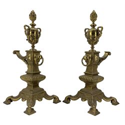 Pair of late Victorian cast and gilt brass fire dogs, circa 1894, with flaming urn finials raised upon columnar supports and four scroll feet, Rd227713, H47cm  