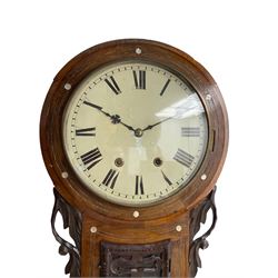 Late 19th century American drop dial clock in a mahogany case with mother of pearl inlay, eight day striking movement striking the hours on a bell, with a 12” painted dial with Roman numerals and Maltese cross hands, flat glass with a spun brass bezel, carved ears and pendulum adjustment door. With Pendulum.