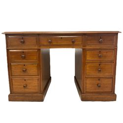 Late 19th century mahogany twin pedestal desk, rectangular top with leather inset writing surface, fitted with central frieze drawer flanked by eight graduating drawers, lower moulded edge over plinth base and castors, each pedestal fitted with faux cupboards to the reverse