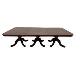 Early Victorian mahogany extending triple pillar dining table, rounded rectangular top with plain skirt, triple turned pedestals each with four splayed supports, lapped carvings to knees and scroll carved terminals with recessed castors, two additional leaves